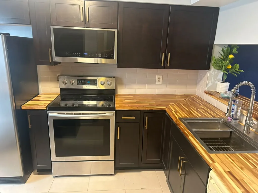 Kitchen with dark cabinets and wood counters after the remodel and clean.